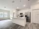 Modern kitchen with white cabinets and stainless steel appliances at 13566 Sw 79Th Terrace Rd, Ocala, FL 34473