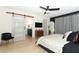 Main bedroom with a barn door leading to the bathroom and a ceiling fan at 1552 East Blvd, Maitland, FL 32751