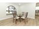 Charming dining area with glass table, four chairs, and an arched window at 1633 Cedar Glen Dr, Apopka, FL 32712