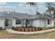 Newly painted exterior, walkway, and well-manicured landscaping at 1633 Cedar Glen Dr, Apopka, FL 32712
