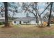 Newly renovated home with fresh white exterior and landscaped yard at 1633 Cedar Glen Dr, Apopka, FL 32712