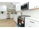 Updated kitchen with white cabinets, stainless steel appliances, and quartz countertops at 1633 Cedar Glen Dr, Apopka, FL 32712