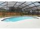 Inviting kidney-shaped pool with a screened enclosure at 1633 Cedar Glen Dr, Apopka, FL 32712