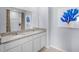 Double vanity bathroom with granite countertops and a walk-in shower at 1705 Frogmore Ave, Haines City, FL 33844