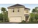 Two-story house with light beige exterior, shutters, and a two-car garage at 1709 Frogmore Ave, Haines City, FL 33844