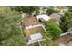 A high angle view shows a property with a white fence, outbuilding, and greenery at 2002 Geigel Ave, Orlando, FL 32806