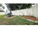 Landscaped backyard featuring a swing and white fence at 2002 Geigel Ave, Orlando, FL 32806