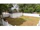Fenced backyard featuring a shed, green grass, and mature trees offering shade and privacy at 2002 Geigel Ave, Orlando, FL 32806
