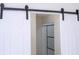 Bathroom access with sliding barn door to a modern shower with glass surround at 2002 Geigel Ave, Orlando, FL 32806