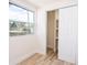 Bright bedroom featuring light wood flooring, closet, and a window that provides natural light at 2002 Geigel Ave, Orlando, FL 32806