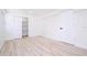 Bright bedroom features wood-look flooring, a closet, and white walls at 2002 Geigel Ave, Orlando, FL 32806