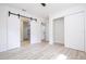 Spacious bedroom with barn door to bathroom and ample closet space at 2002 Geigel Ave, Orlando, FL 32806