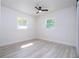 Light-filled bedroom with two windows and a modern ceiling fan at 2002 Geigel Ave, Orlando, FL 32806