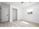Well-lit bedroom featuring sliding closet door and a view of the outside at 2002 Geigel Ave, Orlando, FL 32806