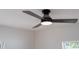 Close-up of a modern, dark-colored ceiling fan with integrated lighting at 2002 Geigel Ave, Orlando, FL 32806