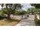 Charming home featuring a white exterior, dark roof, and well-maintained landscaping and gated entry at 2002 Geigel Ave, Orlando, FL 32806