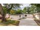 Charming home featuring a white exterior, dark roof, and well-maintained landscaping and gated entry at 2002 Geigel Ave, Orlando, FL 32806
