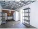 Spacious garage with peg board, storage shelves, refrigerator, and workbench area ready for all projects at 2002 Geigel Ave, Orlando, FL 32806