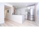 Modern kitchen with granite countertop peninsula and stainless steel refrigerator at 2002 Geigel Ave, Orlando, FL 32806