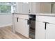 Modern kitchen island with white cabinets, granite countertops, and a built-in wine cooler at 2002 Geigel Ave, Orlando, FL 32806