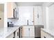 Bright kitchen features granite countertops, stainless steel appliances, and modern white cabinets at 2002 Geigel Ave, Orlando, FL 32806