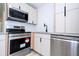 Bright kitchen features granite countertops, stainless steel appliances, and modern white cabinets at 2002 Geigel Ave, Orlando, FL 32806