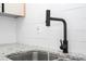 Modern kitchen sink featuring a gooseneck faucet, granite countertops, and a stylish white subway tile backsplash at 2002 Geigel Ave, Orlando, FL 32806