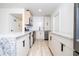 Well-lit kitchen featuring granite countertops, stainless steel appliances, and modern white cabinets at 2002 Geigel Ave, Orlando, FL 32806