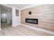 Stylish living room featuring a modern electric fireplace and wood-look flooring at 2002 Geigel Ave, Orlando, FL 32806