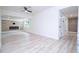 Spacious living room with modern fireplace, ceiling fan and light wood-look floors at 2002 Geigel Ave, Orlando, FL 32806