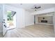 Bright, open living room with wood-look floors and a modern electric fireplace at 2002 Geigel Ave, Orlando, FL 32806