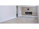 Bright living room with modern fireplace and wood look floors providing a stylish and comfortable space at 2002 Geigel Ave, Orlando, FL 32806