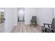 Bright room with gray chairs and view to laundry room and additional room at 2002 Geigel Ave, Orlando, FL 32806