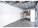 Shed interior with dark floor and overhead shelving for extra storage space at 2002 Geigel Ave, Orlando, FL 32806