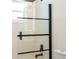 Close up of modern shower with black trimmed glass doors and fixtures at 2002 Geigel Ave, Orlando, FL 32806