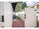 Fenced side yard with red brick walkway and AC unit at 2002 Geigel Ave, Orlando, FL 32806