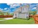 The property includes a spacious backyard, wooden fence, green grass and charming exterior at 219 Laurel Ave, Sanford, FL 32771