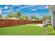 Expansive backyard features a privacy fence, lush green grass, and charming greenery at 219 Laurel Ave, Sanford, FL 32771