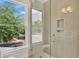 Modern bathroom with glass shower featuring wood-look tiling and built-in storage niche at 219 Laurel Ave, Sanford, FL 32771