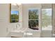 Bathroom with modern fixtures and a window view of lush greenery outside at 219 Laurel Ave, Sanford, FL 32771