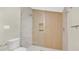 Modern bathroom featuring a glass-enclosed shower, white tile, and contemporary fixtures at 219 Laurel Ave, Sanford, FL 32771