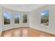 Spacious bedroom with hardwood floors and large windows showcasing scenic outside views at 219 Laurel Ave, Sanford, FL 32771