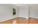 Bright bedroom featuring hardwood floors, closet, and a window with scenic views at 219 Laurel Ave, Sanford, FL 32771