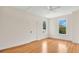 Bright bedroom featuring hardwood floors, ceiling fan, and two windows with scenic views at 219 Laurel Ave, Sanford, FL 32771