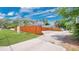 Exterior view of the home highlighting the lush green lawn and wooden fence at 219 Laurel Ave, Sanford, FL 32771