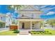Charming two-story home with a covered front porch, beautiful landscaping, and a well-maintained lawn at 219 Laurel Ave, Sanford, FL 32771