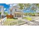 Charming two-story home with a covered front porch and fenced yard on a professionally landscaped lawn at 219 Laurel Ave, Sanford, FL 32771