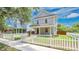 Charming two-story home with a covered front porch, fenced yard, and professionally landscaped lawn at 219 Laurel Ave, Sanford, FL 32771