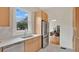 Bright kitchen features stainless steel appliances, light wood cabinets, quartz countertops, and a large window at 219 Laurel Ave, Sanford, FL 32771