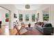 Bright living room with hardwood floors, bay window, and comfortable seating area at 219 Laurel Ave, Sanford, FL 32771
